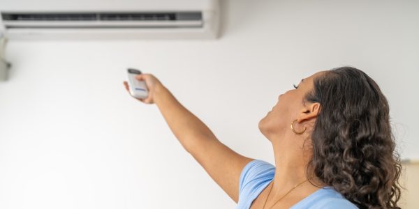 woman-turning-on-air-conditioning-for-relief-from-2025-03-05-05-49-24-utc